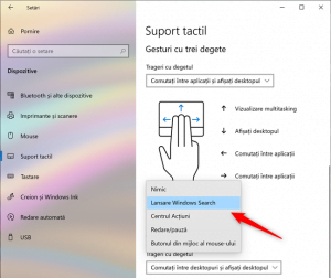 Selectarea acțiunii realizate la atingerea touchpad-ului cu trei sau patru degete