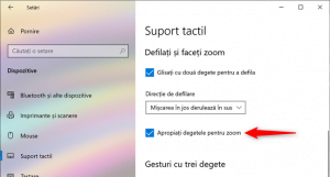Setarea touchpad-ului pentru a face zoom atunci când apropii sau depărtezi două degete pe el