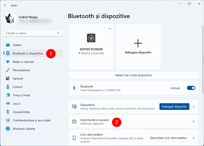 AcceseazÄƒ Bluetooth È™i dispozitive > Imprimante È™i scanere Ã®n SetÄƒrile din Windows 11